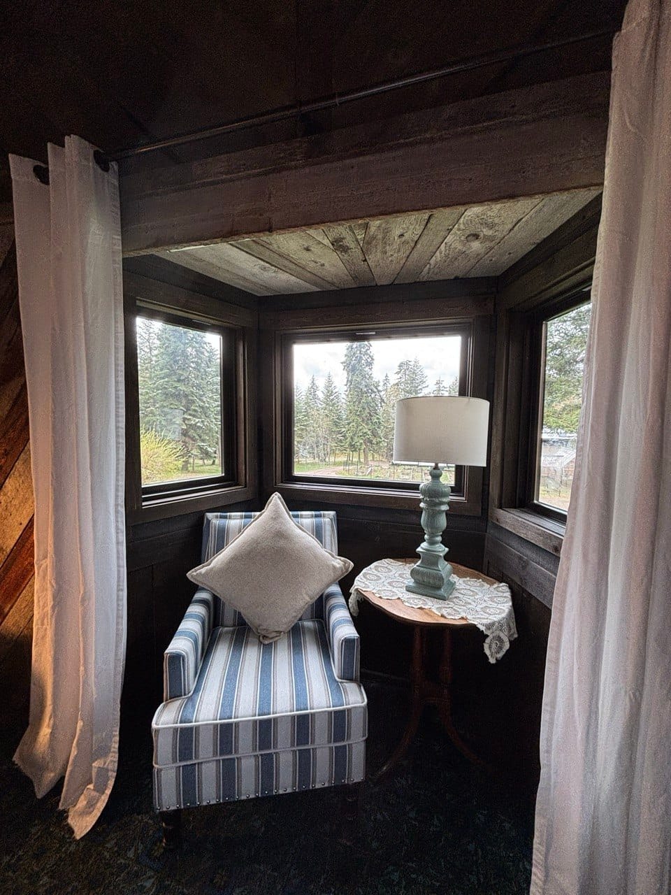 The enclosed porch sitting nook, looking out into the trees
